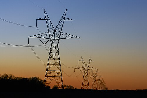Electricity transmission towers at sunset