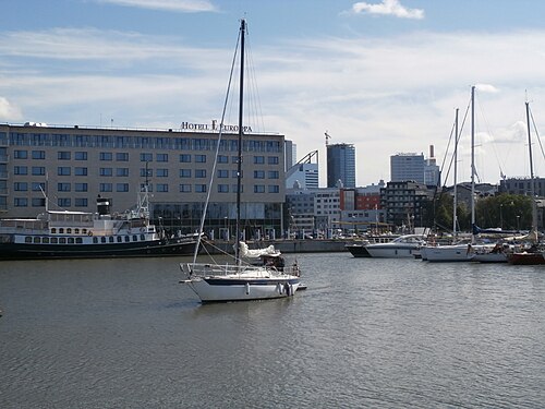 A sailing yacht leaving a marina